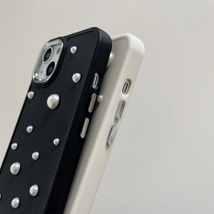 Detail of elegant iPhone cases with pearl embellishments and metallic camera rings