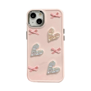 Pink iPhone 16 Pro Max case with 3D bows and heart charms on a sleek silicone cover