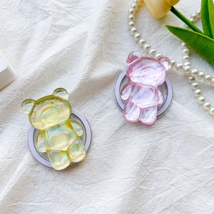 Detail of aurora bear phone stands in green and pink with a metallic magnetic base