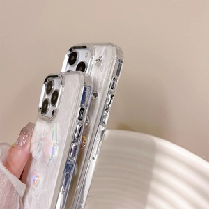 Detailed close-up of pearlescent iPhone case with laser 3D bows and heart charms