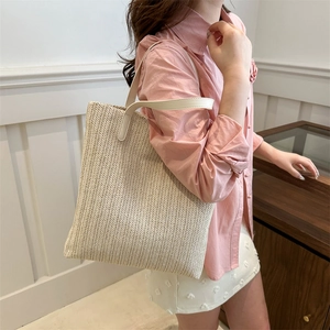Fashionable beige woven straw tote bag with V-shaped texture and leather handles