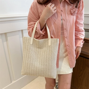 Large capacity beige straw tote bag with minimalist design for summer leisure outfits