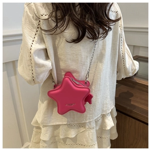 Detailed back view of a pink star-shaped crossbody bag with a slim silver metal chain strap