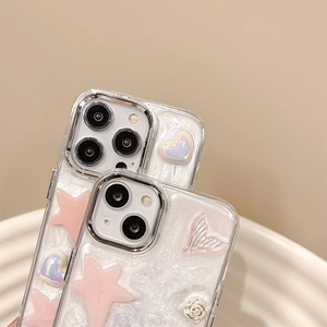 Detail of pink star and pearl heart charms on cream white iPhone case with 3D rose