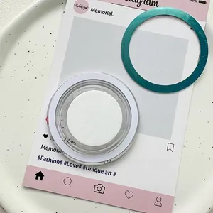 Detail of a turquoise metallic magnetic phone ring holder with its protective packaging