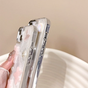 Detail view of pink star and pearl decorations on a clear iPhone protective case