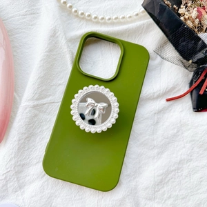 Olive green phone case with pearl mirror and silver bow accessory on white fabric