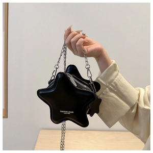 Close-up of black star-shaped crossbody bag with silver chain and leather logo detail