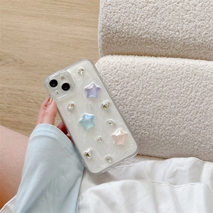 Detail of iPhone case with colorful 3D stars and sparkling rhinestones in hand