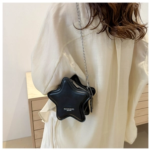 Detail of star-shaped crossbody bag with silver chain strap and leather texture