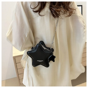 Detail of star-shaped black leather bag with silver chain strap and fashion logo