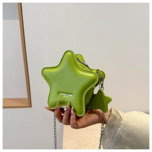 Macro shot of neon green star-shaped mini crossbody bag with silver chain strap