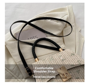 Close-up of straw woven crossbody bag with flower embroidery and metal turn-lock