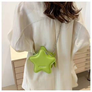 Detail of green star-shaped crossbody bag with silver chain strap and fashion text