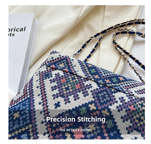 Detailed close-up of ethnic jacquard fabric texture and woven chain strap on tote bag