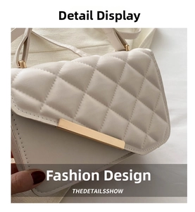 Detail of quilted small crossbody bag featuring elegant gold metal bar and beige texture