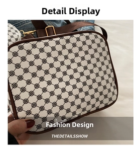 Detail view of vintage crossbody bag featuring clover monogram print and wide strap