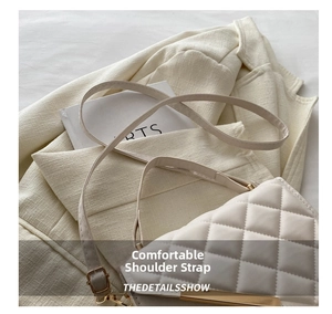 Detail of quilted beige shoulder bag with adjustable gold buckle and elegant strap