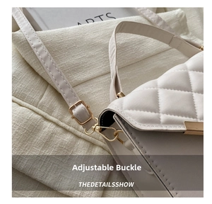 Detail of white quilted crossbody bag with adjustable gold buckle and thin strap