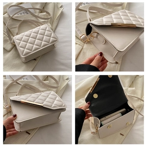 Detail view of cream quilted crossbody bag with gold hardware and spacious interior