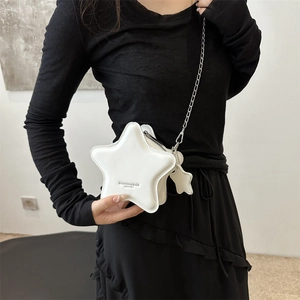 White star-shaped crossbody bag with silver chain strap and mini star pendant charm