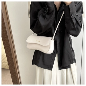 Detail of minimalist white half-moon crossbody bag with gold Fashion & Bags lettering