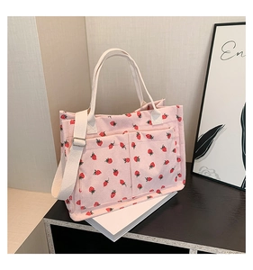 Detailed corduroy texture of pink strawberry tote bag with functional front dual pockets