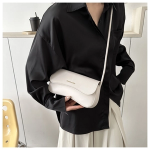Detail of white PU leather crossbody bag with gold Fashion & Bags lettering on flap