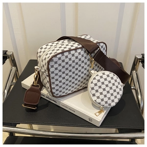 Detail of retro crossbody camera bag with mini coin purse and patterned brown wide strap
