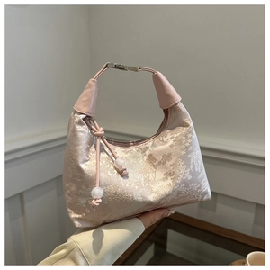 Detail of pink satin jacquard handbag with landscape patterns and beaded tassels