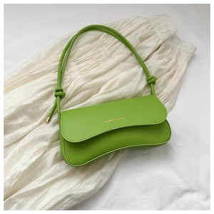 Detail view of green faux leather shoulder bag with knot strap and metallic logo lettering