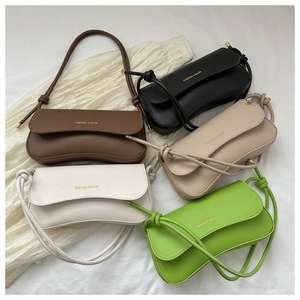 Flat lay of five minimalist baguette bags in black, coffee, apricot, white, and green