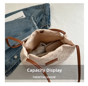 Macro shot showing the spacious interior of a woven tote bag with daily essentials