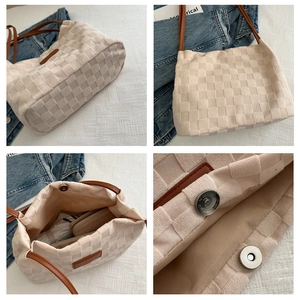 Detail view of woven tote bag showing magnetic clasp, interior space, and textured fabric