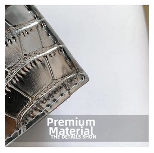 Detailed macro view of silver crocodile embossed leather texture with glossy finish