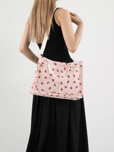 Pink corduroy tote bag with red strawberry pattern and white straps for women