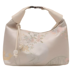 Floral print crescent bucket bag in beige with metallic clasp and decorative drawstring