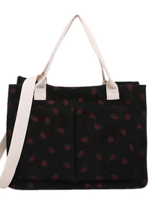Corduroy tote bag with strawberry pattern featuring dual front pockets and shoulder straps