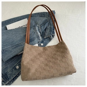 Detail of coffee checkered tote bag with 3D knitted texture and brown leather straps