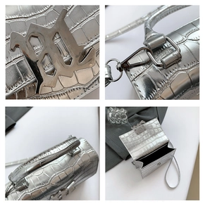 Detail showing the silver embossed crocodile pattern and gothic metal logo on the bag