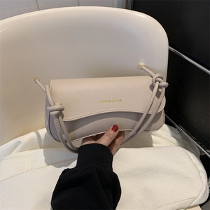 Chic cream white crossbody underarm bag with knot strap and gold fashion logo