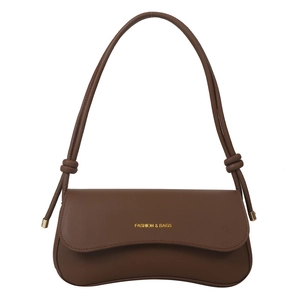 Minimalist brown leather shoulder bag for women with decorative knotted strap and gold hardware