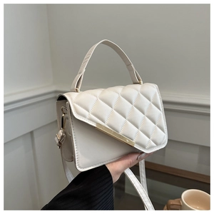 Elegant white quilted crossbody bag with gold accents and adjustable shoulder strap