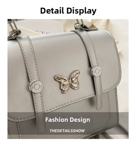 Detail of silver metallic handbag with butterfly clasp and refined matte texture