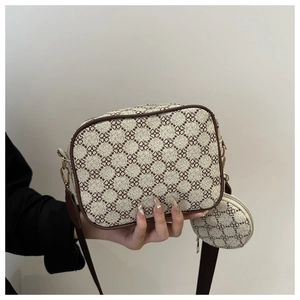 Detailed view of crossbody camera bag set with brown clover pattern and mini coin purse