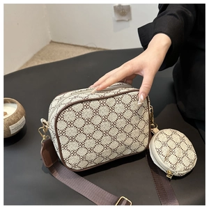 Detail of clover print crossbody bag with detachable coin purse and wide strap