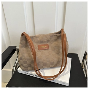 Close-up of khaki checkered tote bag showing textured fabric and leather straps
