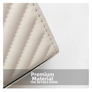 Close-up of premium cream faux leather featuring detailed V-shaped quilted stitching