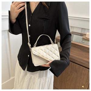 White quilted faux leather crossbody bag with gold metal trim and top handle for women