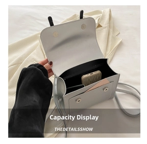 Interior view of small silver metallic crossbody bag showing phone and card storage